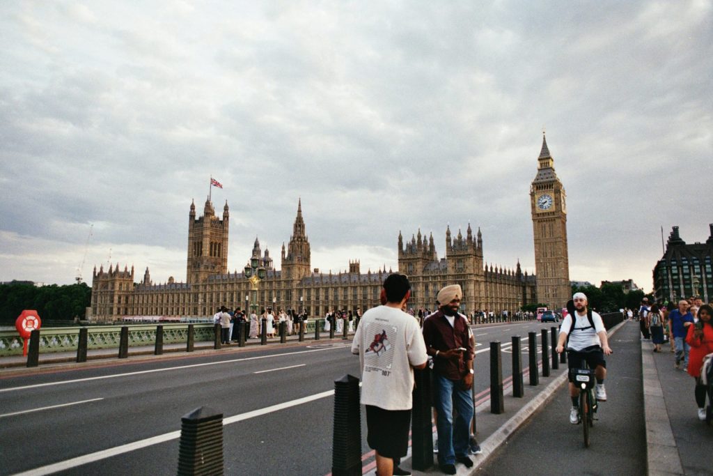 People visit the palace of westminster and big ben.