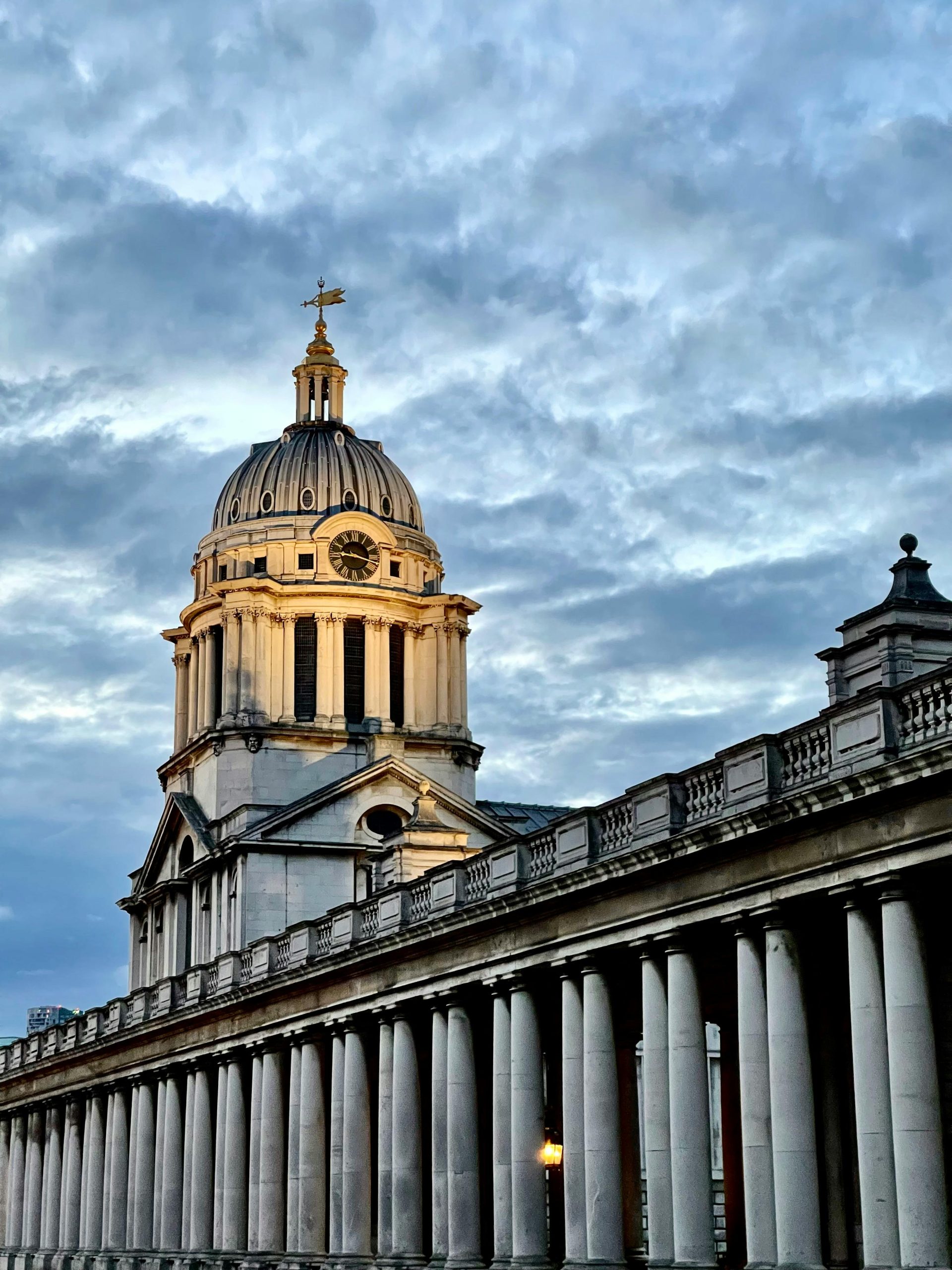 Stunning architecture of London's Old Royal Naval College against a cloudy sky.