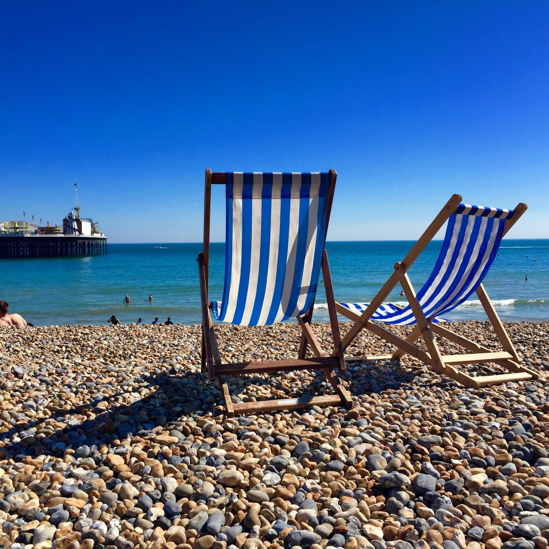brown wooden chair on beach during daytime