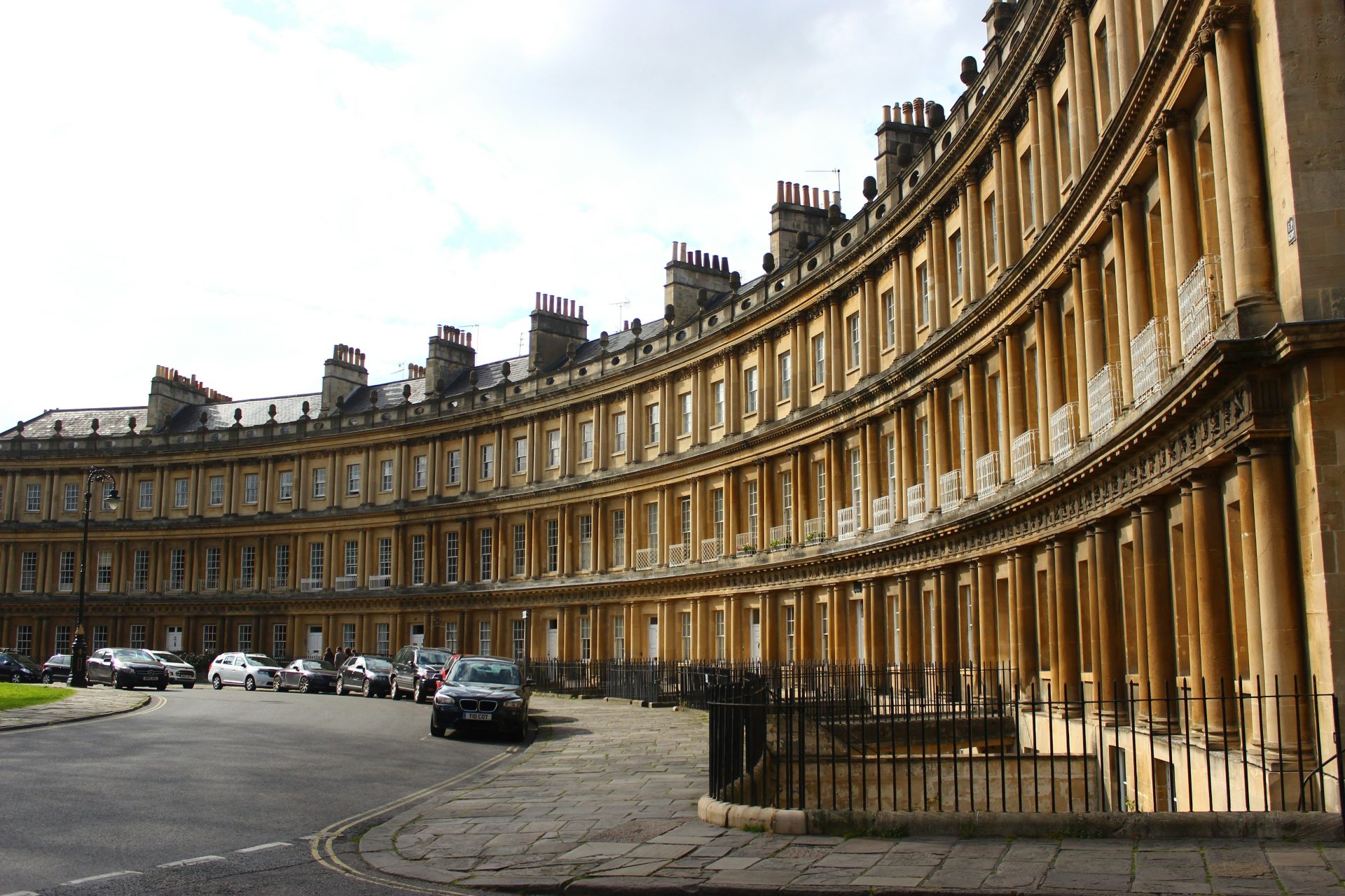 a curved building with cars parked in front of it