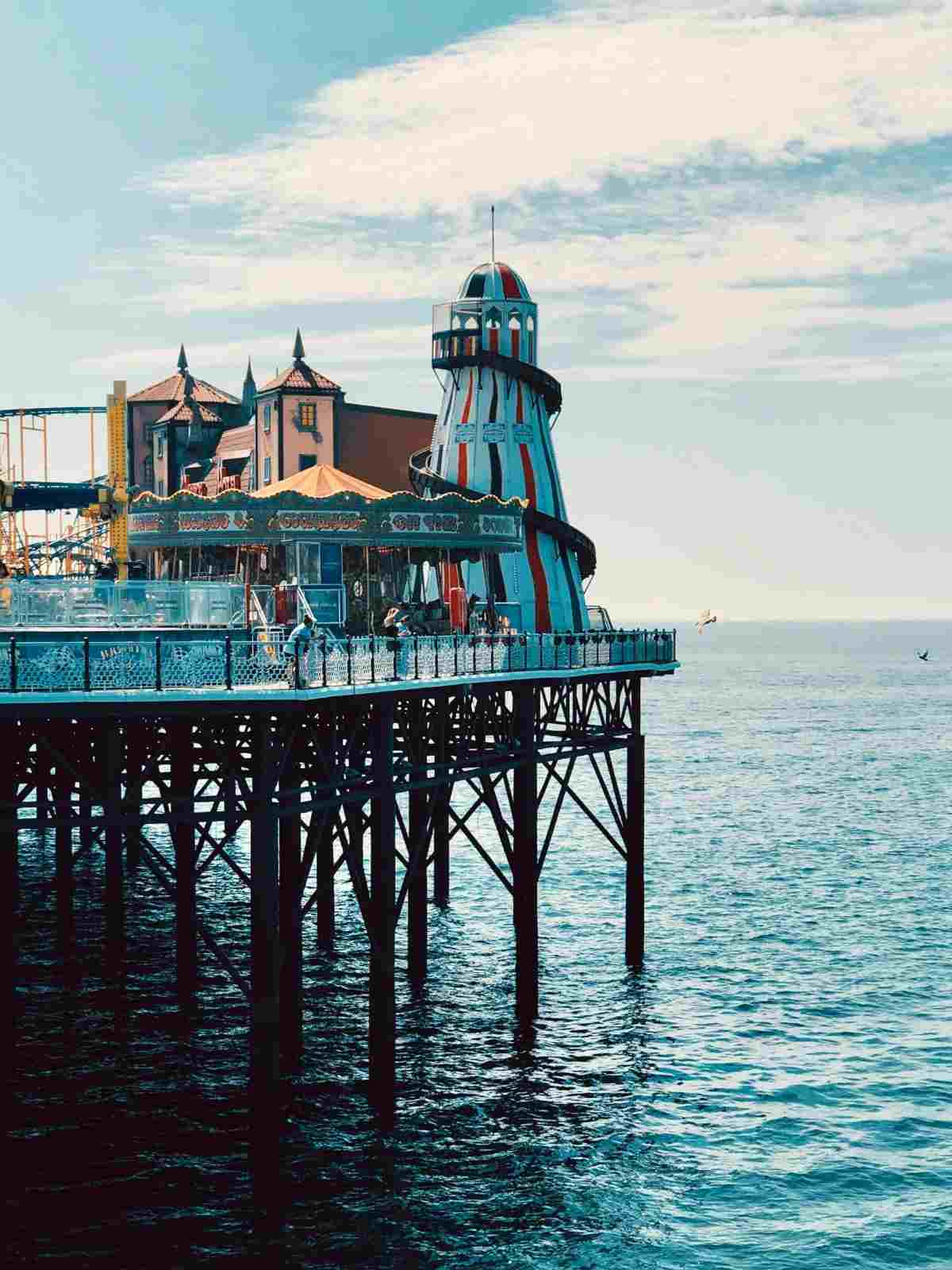 lighthouse on pier under white sky